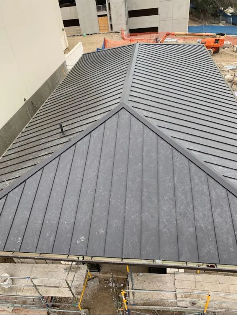 Commercial metal roof construction with crane equipment in Bayonet Point