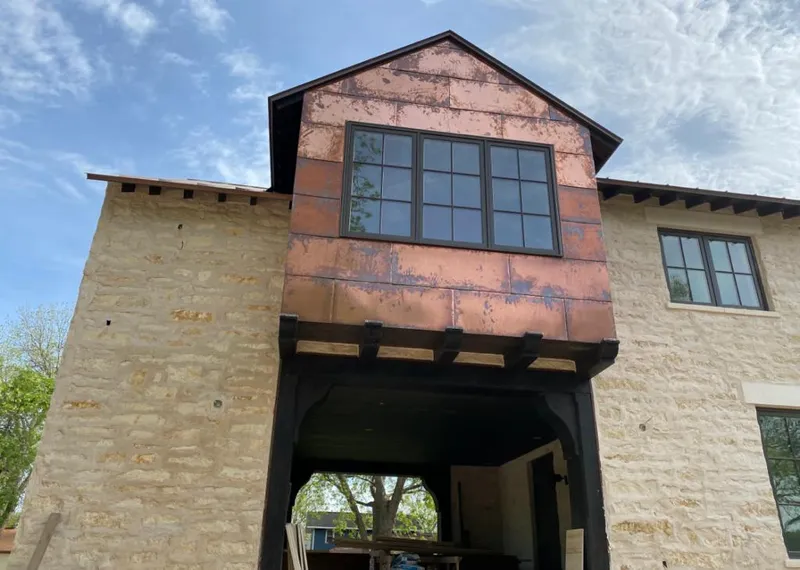 Copper metal panel facade on a stone building for Skylight Installation in Bayonet Point